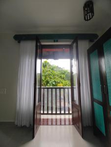 an open door with a view of a balcony at Shivam bnb Boutique Apartments in Mandrem
