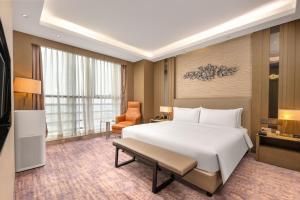 Postel nebo postele na pokoji v ubytování The Qube Xuzhou