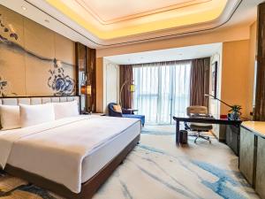 Ένα ή περισσότερα κρεβάτια σε δωμάτιο στο Wanda Vista Kunming