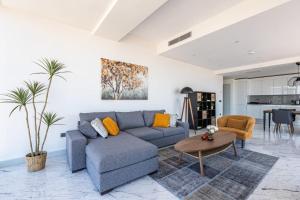 a living room with a blue couch and a table at Beautiful Bright Deluxe 1bd Condo Poolviews! #311 in Istanbul