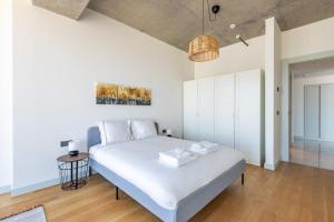 a bedroom with a large white bed in a room at Beautiful Bright Deluxe 1bd Condo Poolviews! #311 in Istanbul +24 photos