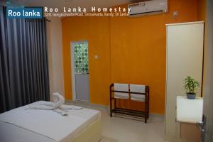 Postel nebo postele na pokoji v ubytování Roo Lanka Homestay