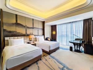 Ένα ή περισσότερα κρεβάτια σε δωμάτιο στο Wanda Vista Kunming