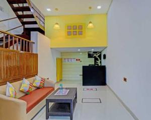 a living room with a couch and a table at Super Collection O Vardhan House in Pune