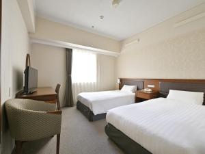 Postel nebo postele na pokoji v ubytování Rihga Hotel Zest Takamatsu