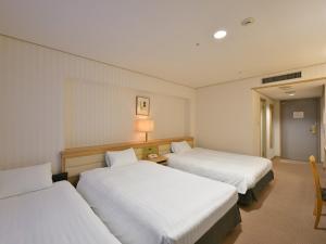 Postel nebo postele na pokoji v ubytování Rihga Hotel Zest Takamatsu