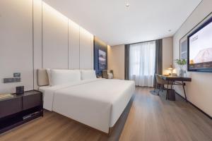 Postelja oz. postelje v sobi nastanitve Atour Hotel Jinan Shandong International Convention and Exhibition Center Ikea