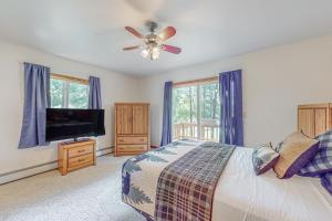 a bedroom with a bed and a ceiling fan at Tall Pines in Woodruff