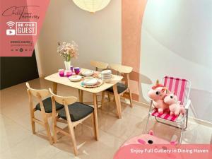 a dining room with a table and chairs with a toy pig at Paradigm Mall JohorBahru- Hyatt Palace 5GWifi Netflix by ChillTime Homestay in Johor Bahru