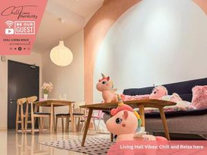 a living room with a couch and a table with dolls at Paradigm Mall JohorBahru- Hyatt Palace 5GWifi Netflix by ChillTime Homestay in Johor Bahru