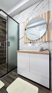 a bathroom with a sink and a mirror at ND Apartments in Bar