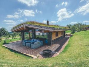 a building with a grass roof on a deck at Chalets Resort in Cínovec