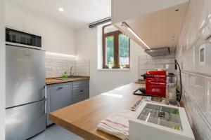 a kitchen with white appliances and a wooden counter top at Monbuhim Twin in Veszprém