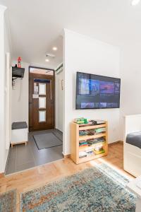a living room with a flat screen tv on a wall at Monbuhim Twin in Veszprém