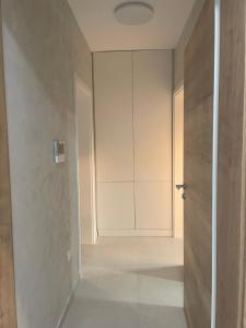 an empty hallway with a door and a room at Lavander Apartment W Pool and Private Beach in Tivat +15 photos