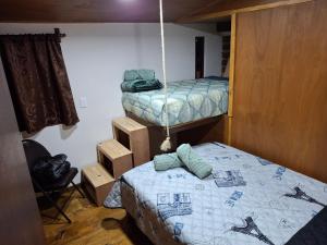 a room with two beds and a hanging bed at Cabañas De La Vega in Tomatlán