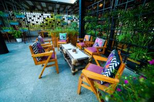 a group of chairs and a table with pillows at Hotel Surya, Kaiser Palace in Varanasi
