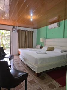 Postel nebo postele na pokoji v ubytování Tortuguero Hill Rooms