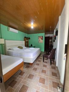 Postel nebo postele na pokoji v ubytování Tortuguero Hill Rooms