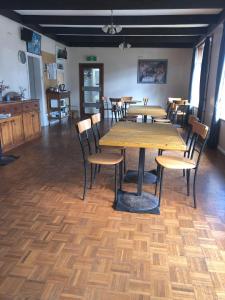 a dining room with wooden tables and chairs at Yarrabin Country Retreat in OʼConnell