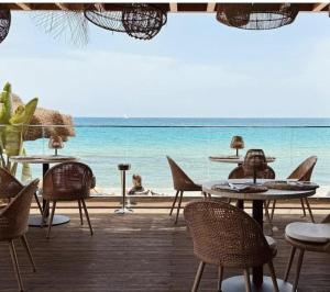 a group of tables and chairs and the ocean at Sinclair , loft in center with original romantic fresco in Cagliari