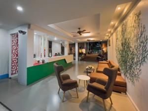 a lobby with a couch and chairs and a table at Melissa Kata Beach Resort in Kata Beach