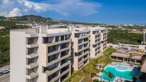 an aerial view of a building with a swimming pool at Luxury Beachfront Apartment in Cabo in Cabo San Lucas