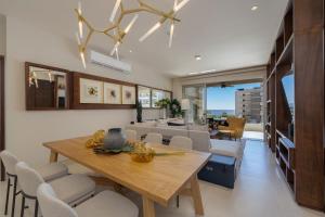 a dining room with a table and chairs at Luxury Beachfront Apartment in Cabo in Cabo San Lucas