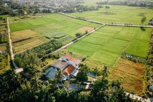 an aerial view of a house in a field at Bong Villa Hoi An - Vesta Collections in Hoi An