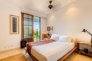 a bedroom with a large bed and a window at De Old Sport - Vesta Collections in Ho Chi Minh City +30 photos