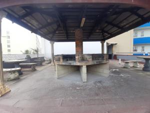 a picnic shelter with benches in a parking lot at Unit 606 Seabrook in Margate