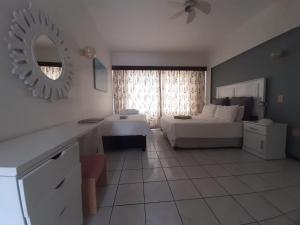 a room with a bedroom with a bed and a mirror at Unit 606 Seabrook in Margate