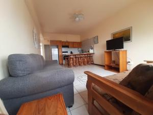 a living room with a couch and a kitchen at Unit 606 Seabrook in Margate