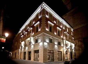 a large building with lights on it at night at Le Camp Suite & Spa in Padova