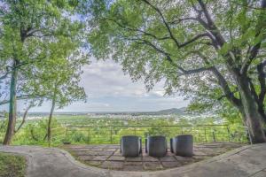 a circular archway in a park with trees at The Gateway Hotel Pasumalai Madurai in Madurai