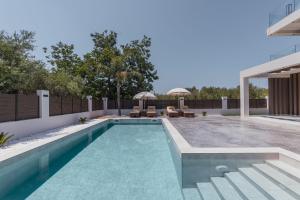 a swimming pool in the backyard of a house at Infinity Holiday Villas - Private Pool, close to Kalamaki Centre, by ZanteWize in Kalamaki