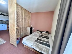 a bedroom with a bed in a room with a wall at Le Refuge de Lola & Bruno in Les Déserts