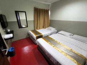 Postel nebo postele na pokoji v ubytování HOTEL BINTANG