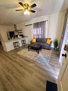 a living room with a couch and a table at Lakewoodlyon Park Renovated Cottage Near Duke 28b in Durham