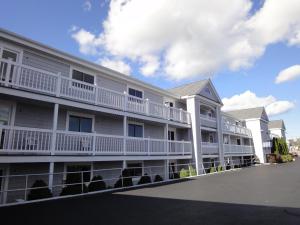 a large apartment building with white balconies at Hyannis Travel Inn in Hyannis