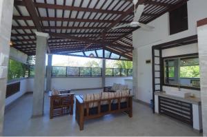 a living room with a patio with a table and chairs at Fisherman Lodge Mawella in Tangalle