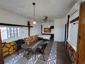 a room with a bed and a table and chairs at Casa con alberca frente del mar de Santa clara Yucatan in Santa Clara
