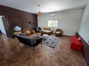 a living room with a couch and chairs and a table at Casa con alberca frente del mar de Santa clara Yucatan in Santa Clara