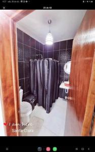 a bathroom with a shower and a toilet and a sink at Casa con alberca frente del mar de Santa clara Yucatan in Santa Clara