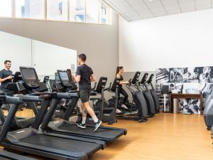 a group of people exercising on treadmills in a gym at H&ocirc;tel Lyon M&eacute;tropole in Lyon