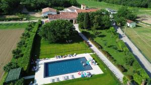 an overhead view of a large swimming pool in a garden at Tenuta Le Sorgive Agriturismo in Solferino