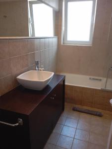 a bathroom with a sink and a bath tub at Tiny Little SUITE in Athens +23 photos