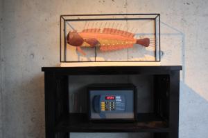 a picture of a fish sitting on top of a microwave at Cottage Hakuraku in Onna +20 photos