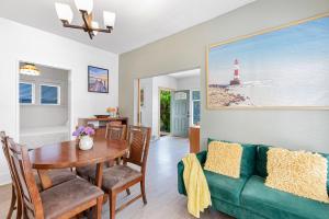 a living room with a green couch and a table at Vintage 3 Bedroom Home in Prime Eastlake Seattle with Private Parking in Seattle
