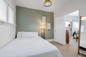 a bedroom with a large white bed and a hallway at Vintage 3 Bedroom Home in Prime Eastlake Seattle with Private Parking in Seattle